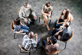 Group of students sitting in a circle in a discussion